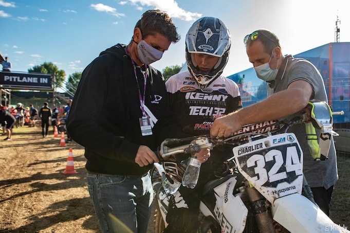 Motocross rider with his mechanics