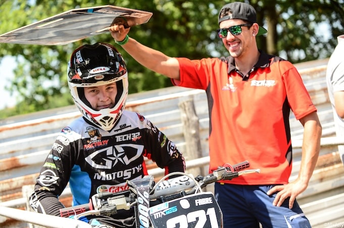 A motocross rider and his mechanic before the start of a race