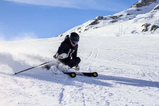 Skier making a turn on a snow-covered piste