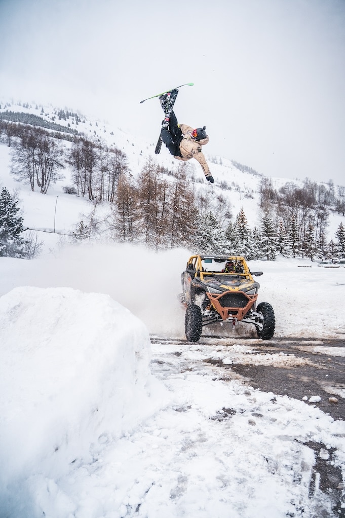 Photo of a skier jumping over a 4x4