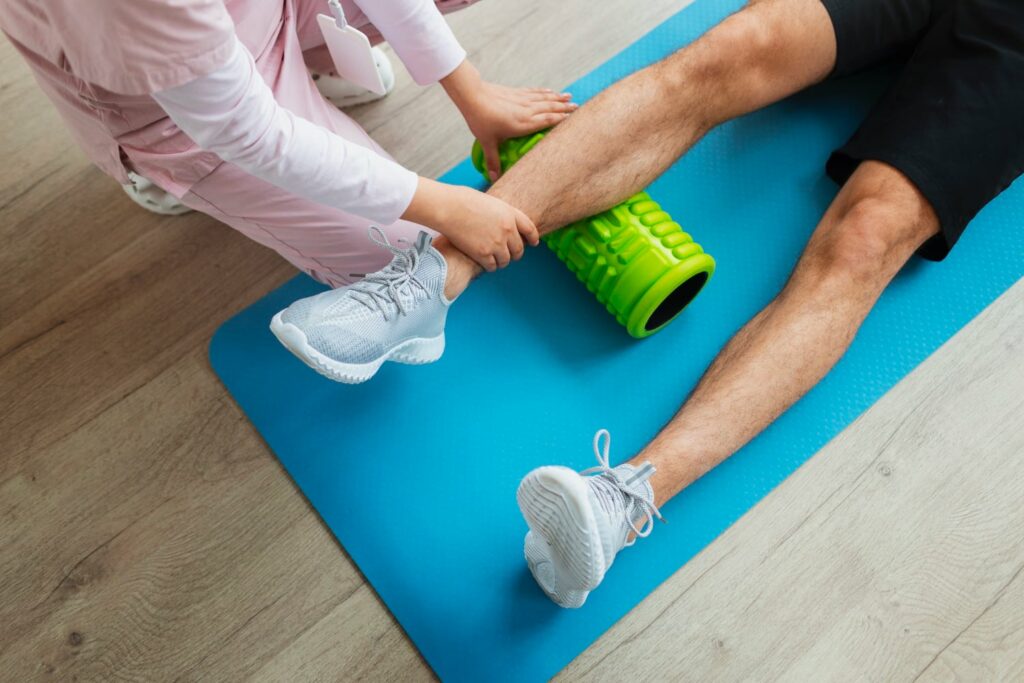 Doctor helping patient during rehabilitation