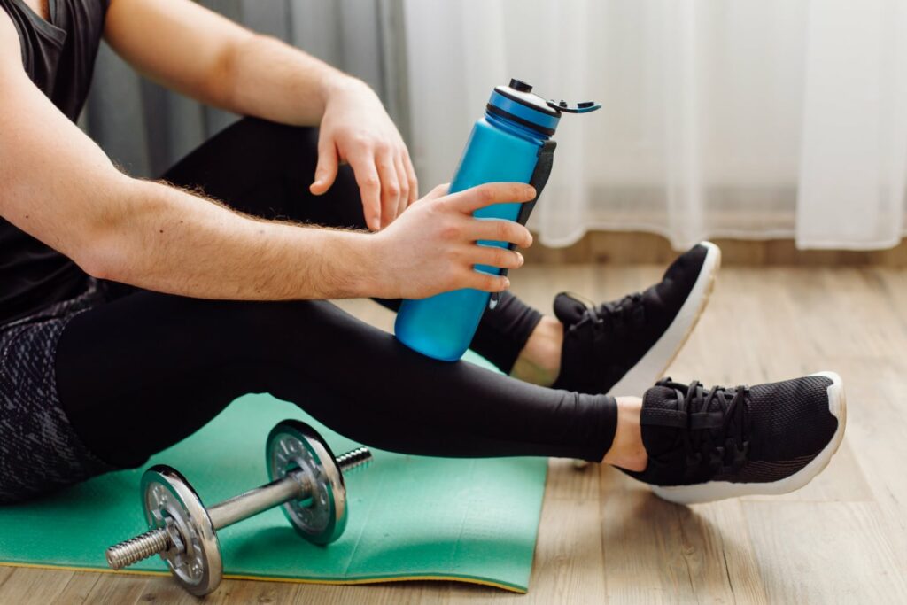 Young man making sport exercises at home