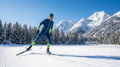 dynamic-skier-on-groomed-track-mountain-backdrop